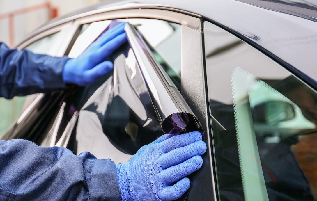 Window tinting film installation on car in Toronto